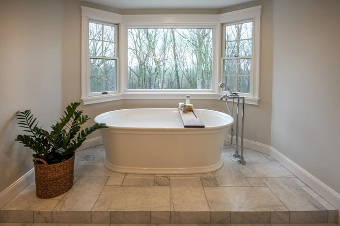 freestanding soaking tub near large windows in Lexington, MA