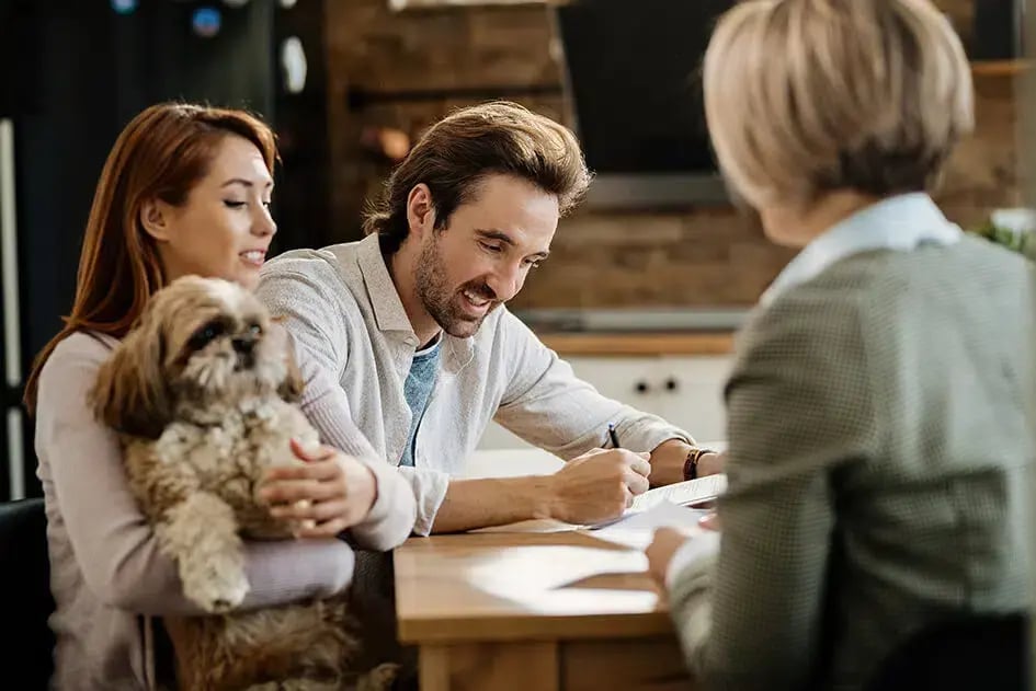 Family with a dog signing an agreement