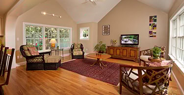 Living room with chairs, rug, coffee table and tv console