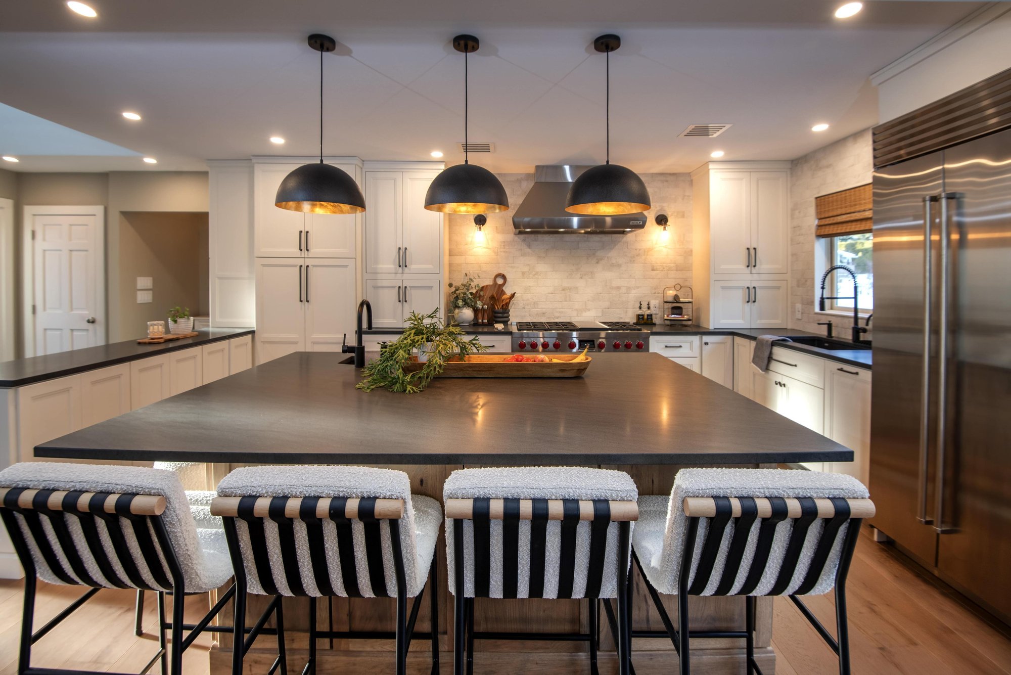 A large, square kitchen island in an Andover, MA home remodeled by Blackdog Design/Build/Remodel