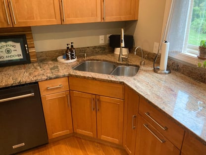 A corner sink view in a kitchen in an Andover, MA home prior to a remodel done by Blackdog Design/Build/Remodel