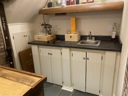 wet bar area with cabinetry and white paneling