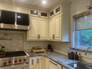 A "before" perspective of a kitchen stove and sink before a remodel and transformation was completed by Blackdog Design/Build/Remodel in Andover, MA