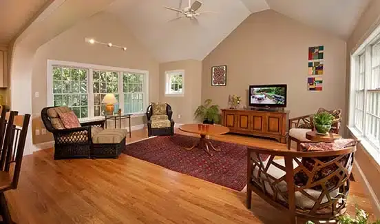 Kitchen with granite counters, white cabinets, and barstool chairs