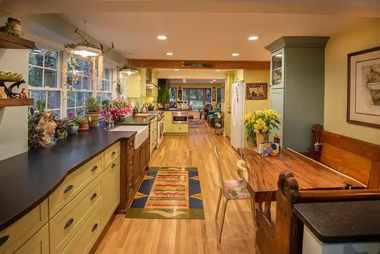 Colorful kitchen renovation with plants, wooden, pastel green, and yellow accents.