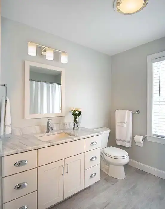 Bathroom with black granite countertop and toilet