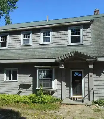 vintage home with dark hardwood and an archway leading to the kitchen