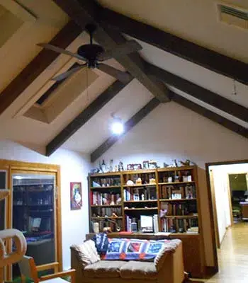 living room ceiling with dark beams running across