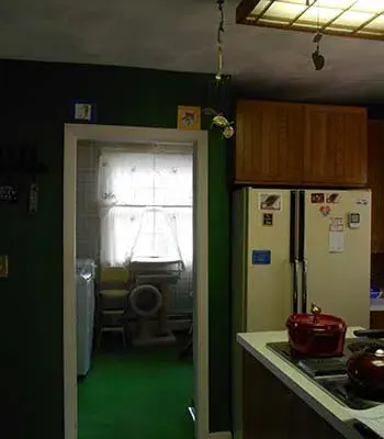 living room ceiling with dark beams running across
