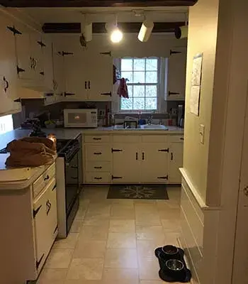 Out-dated white kitchen with rustic cabinets