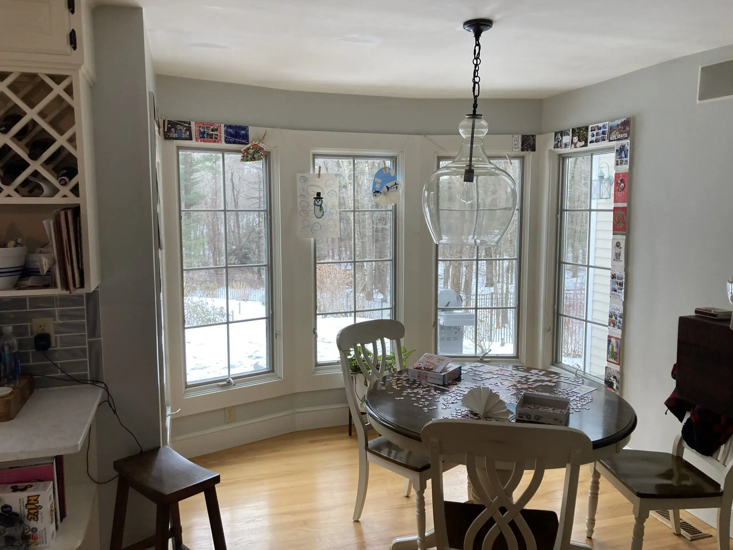 Kitchen with white cabinets, black door knobs, and white marble countertops