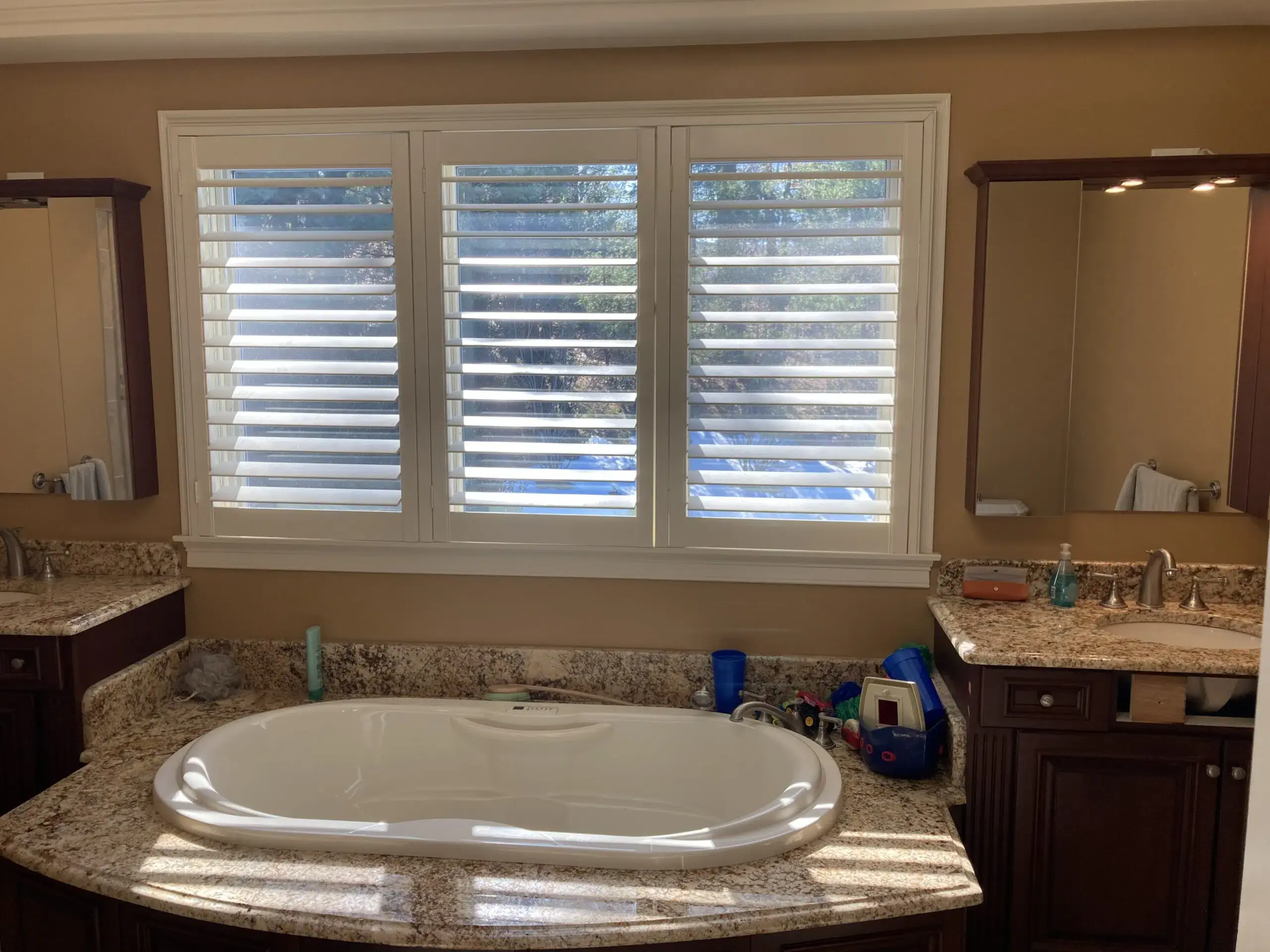 Tan-tiled standing shower with the door open