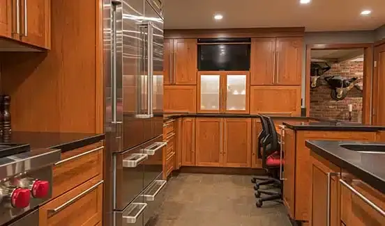 Kitchen with black-trimmed windows, black marbled backsplash, wooden cabinetry, and stainless steel accents