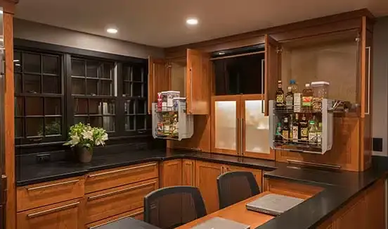 Kitchen with black-trimmed windows, black marbled backsplash, wooden cabinetry, and stainless steel accents