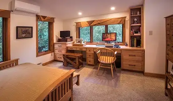 Outdoor screened in room with chairs and white accents