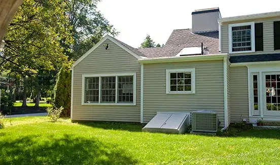 Kitchen with granite counters, white cabinets, and barstool chairs