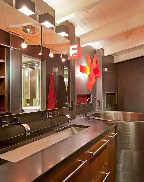 Bathroom with wooden cabinets and steel sink