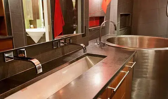 Bathroom with wooden cabinets and steel sink
