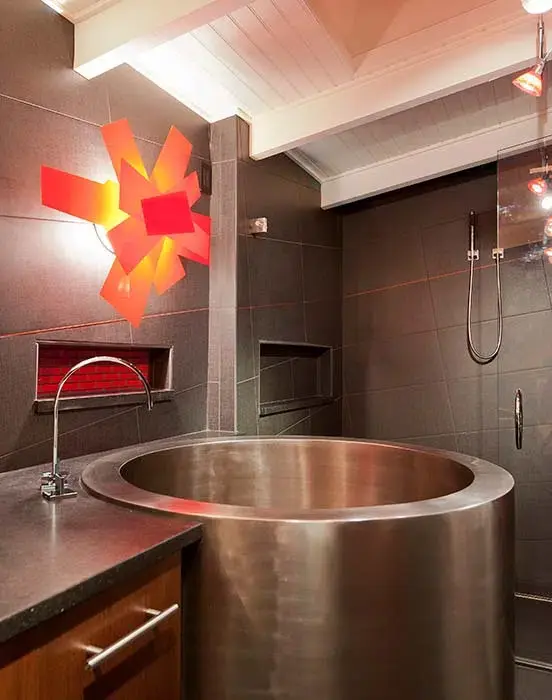 Bathroom with wooden cabinets and steel sink