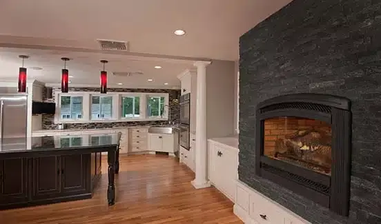 A custom designed kitchen and family room with a built-in fireplace.
