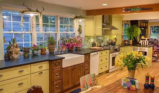 Colorful kitchen renovation with plants, wooden, pastel green and yellow accents