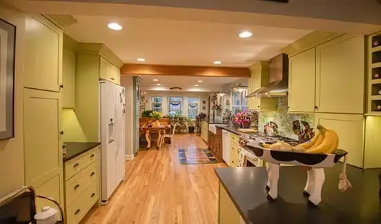 Colorful kitchen renovation with plants, wooden, pastel green and yellow accents