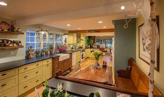 Colorful kitchen renovation with plants, wooden, pastel green and yellow accents