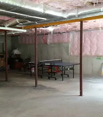 Dark unfinished basement with windows installed