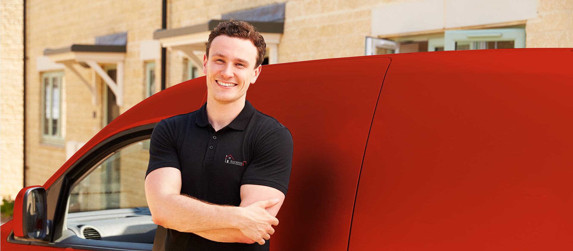 Blackdog Design/Build professional smiling while standing in front of a red service truck.